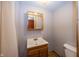 Compact bathroom featuring a wood vanity with sink, mirrored medicine cabinet and a toilet at 1630 Hinson Rd, Martinsville, IN 46151