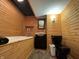 Unique bathroom with wood paneling, bathtub, and black toilet creates a rustic modern feel at 1630 Hinson Rd, Martinsville, IN 46151
