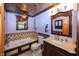 Elegant bathroom featuring a luxurious soaking tub, stylish vanity, and decorative ceiling at 1630 Hinson Rd, Martinsville, IN 46151