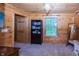 Spare bedroom featuring rustic wood paneling, natural light, and neutral carpet at 1630 Hinson Rd, Martinsville, IN 46151