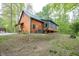 Charming log cabin home with a green roof and a partially-covered front porch at 1630 Hinson Rd, Martinsville, IN 46151