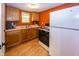Functional kitchen with wooden cabinets, gas stove, and white refrigerator at 1630 Hinson Rd, Martinsville, IN 46151