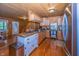 A rustic-style kitchen with wood paneling, custom cabinets, stainless steel refrigerator, and an island at 1630 Hinson Rd, Martinsville, IN 46151