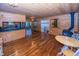 Open living room with wood burning stove, hardwood floors, and kitchen view for easy entertaining at 1630 Hinson Rd, Martinsville, IN 46151