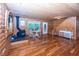 Relaxing living room featuring hardwood floors, a wood-burning stove, and access to a staircase at 1630 Hinson Rd, Martinsville, IN 46151