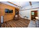 Spacious living room with wood-paneled accent wall, modern chandelier, and hardwood floors at 1630 Hinson Rd, Martinsville, IN 46151