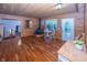 Spacious living room with hardwood floors, wooden walls, a cozy wood stove, and staircase access at 1630 Hinson Rd, Martinsville, IN 46151