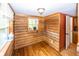 Cozy room featuring wood paneling, natural light from two windows, and neutral flooring at 1630 Hinson Rd, Martinsville, IN 46151