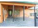 Charming covered porch with wood floors, string lights and a bench, perfect for relaxing outdoors at 1630 Hinson Rd, Martinsville, IN 46151