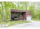 Exterior view of a shed with one garage door and an open space for storing vehicles at 1630 Hinson Rd, Martinsville, IN 46151