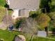 Aerial view of the backyard featuring a patio, fenced yard, mature trees, and outdoor play area at 18811 Orleans Ct, Noblesville, IN 46060