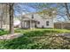 Spacious backyard showcasing a screened-in porch, lush lawn, mature trees, and play set, great for entertaining at 18811 Orleans Ct, Noblesville, IN 46060
