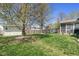 Large backyard with mature trees, play set, and shed, offering ample space for outdoor activities and storage at 18811 Orleans Ct, Noblesville, IN 46060
