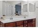The bathroom features double sinks, dark wood cabinets, and a large mirror at 18811 Orleans Ct, Noblesville, IN 46060