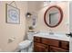 Cozy powder room featuring charming decor and a round mirror above the vanity at 18811 Orleans Ct, Noblesville, IN 46060