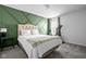 Comfortable bedroom featuring a bed, accent wall, and exercise bike at 18811 Orleans Ct, Noblesville, IN 46060