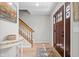 Inviting foyer features hardwood floors, staircase, and a decorative rug, leading to the home's interior at 18811 Orleans Ct, Noblesville, IN 46060