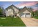 Charming two-story home with a well-manicured lawn and attached two-car garage at 18811 Orleans Ct, Noblesville, IN 46060