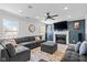 Spacious living room with plush sectional sofa, fireplace, and large windows, perfect for relaxation at 18811 Orleans Ct, Noblesville, IN 46060