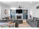 Cozy living room featuring a fireplace, ceiling fan, and comfortable seating area perfect for Gathering gatherings at 18811 Orleans Ct, Noblesville, IN 46060