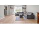Comfortable living room with light wood floors, gray sectional sofa, and a view to the outside at 18811 Orleans Ct, Noblesville, IN 46060
