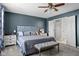Relaxing main bedroom featuring a padded headboard, carpet, and two closets with a view to a bathroom at 18811 Orleans Ct, Noblesville, IN 46060