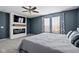 This main bedroom includes a ceiling fan, a fireplace and a view to the outside at 18811 Orleans Ct, Noblesville, IN 46060