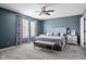 Relaxing main bedroom featuring a padded headboard, carpet, and two windows at 18811 Orleans Ct, Noblesville, IN 46060