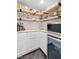 Walk-in pantry with a built-in refrigerator and bright, stylish wooden shelving at 18811 Orleans Ct, Noblesville, IN 46060
