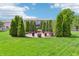 Landscaped backyard with a stone patio, perfect for outdoor entertaining and relaxation at 19248 Searay Dr, Noblesville, IN 46060