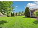 Lush backyard with well-maintained lawn and mature trees, ideal for outdoor activities at 19248 Searay Dr, Noblesville, IN 46060