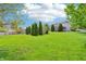 Spacious backyard featuring a lush lawn and mature trees providing privacy and shade at 19248 Searay Dr, Noblesville, IN 46060