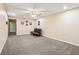 Finished basement area with neutral carpeting, a ceiling fan, recessed lighting, and a modern futon at 19248 Searay Dr, Noblesville, IN 46060