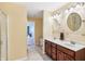 Well-lit bathroom showcasing double sink vanity and a shower with glass door on a tile floor at 19248 Searay Dr, Noblesville, IN 46060