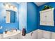 Bright blue bathroom featuring a pedestal sink, medicine cabinet, and toilet at 19248 Searay Dr, Noblesville, IN 46060