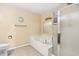 Cozy bathroom features a shower with glass doors, and a large white soaking tub at 19248 Searay Dr, Noblesville, IN 46060