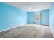 Bright blue bedroom with neutral carpet, ceiling fan and good light from a large window at 19248 Searay Dr, Noblesville, IN 46060