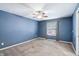 Blue bedroom with carpet, ceiling fan, and a window with patterned curtains at 19248 Searay Dr, Noblesville, IN 46060