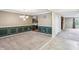 Spacious dining room featuring carpeted floors, a chandelier, and decorative wall paneling at 19248 Searay Dr, Noblesville, IN 46060