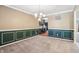 Carpeted dining room with decorative wall paneling and a view into the kitchen at 19248 Searay Dr, Noblesville, IN 46060