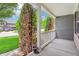 Inviting front porch with white railing and columns, offering a view of the green lawn and street at 19248 Searay Dr, Noblesville, IN 46060