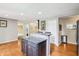 Spacious kitchen island with granite countertops, hardwood floors, and stainless appliances at 19248 Searay Dr, Noblesville, IN 46060