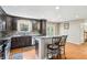 Stylish kitchen boasts dark cabinets, granite counters, stainless appliances, and hardwood flooring at 19248 Searay Dr, Noblesville, IN 46060