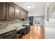 Gourmet kitchen with a built in desk, granite countertops, and dark wood cabinets at 19248 Searay Dr, Noblesville, IN 46060