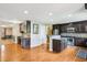 Open kitchen concept with dark cabinetry, granite countertops, and stainless steel appliances at 19248 Searay Dr, Noblesville, IN 46060