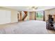 Carpeted living room with natural light, stairs, and an adjacent hallway at 19248 Searay Dr, Noblesville, IN 46060