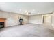 Spacious living room with a fireplace, ceiling fan, and neutral color palette at 19248 Searay Dr, Noblesville, IN 46060