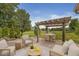 Inviting outdoor seating area with a pergola, comfortable furniture, and a view of the expansive backyard, perfect for gatherings at 19552 Wagon Trail Dr, Noblesville, IN 46060