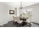 Formal dining room with elegant chandelier, soft carpet, and bright natural light at 19552 Wagon Trail Dr, Noblesville, IN 46060