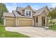 Attractive two-story home boasting a three-car garage, stone accents, and a covered porch, offering great curb appeal at 19552 Wagon Trail Dr, Noblesville, IN 46060
